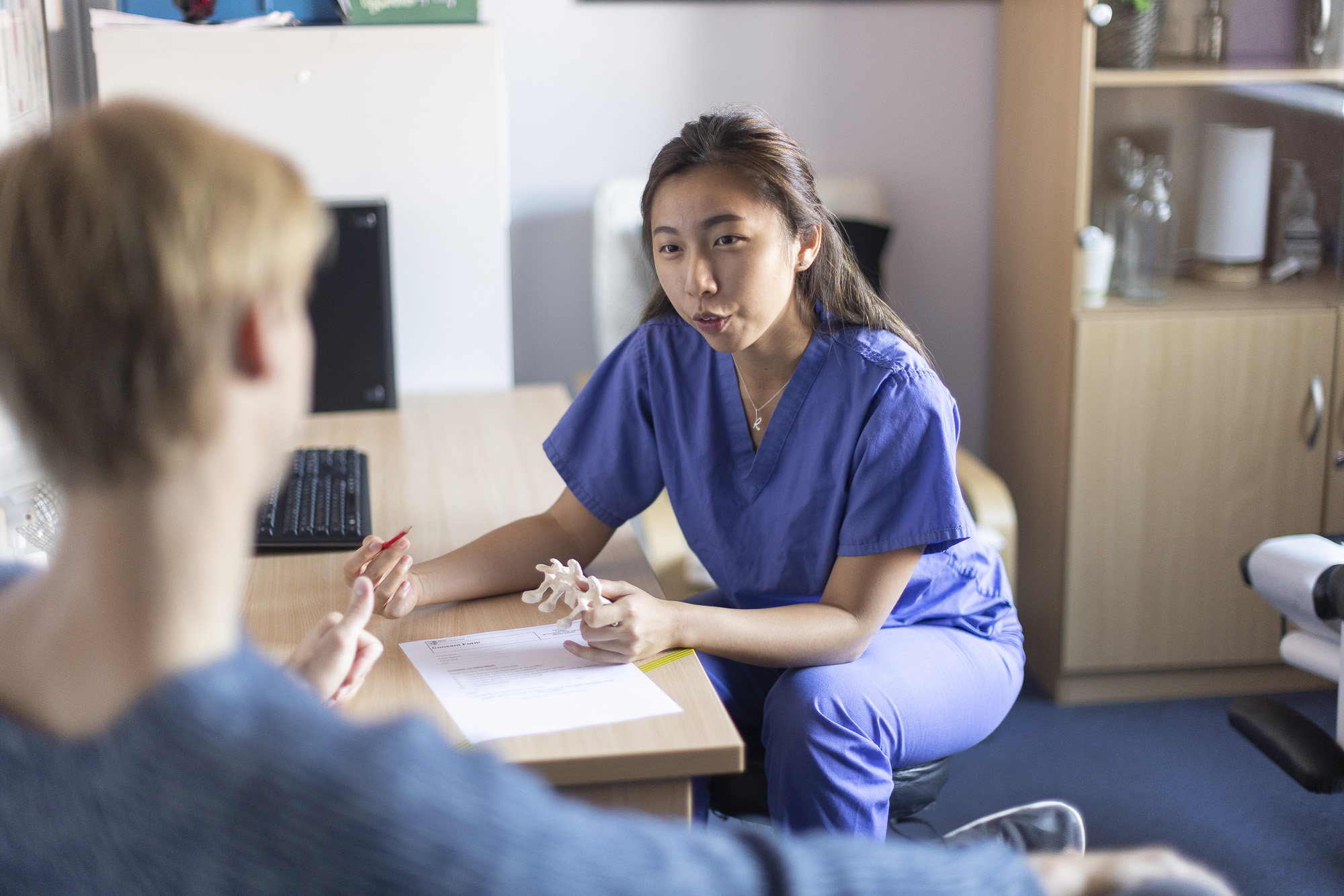 Female chiropractic Student in consultation