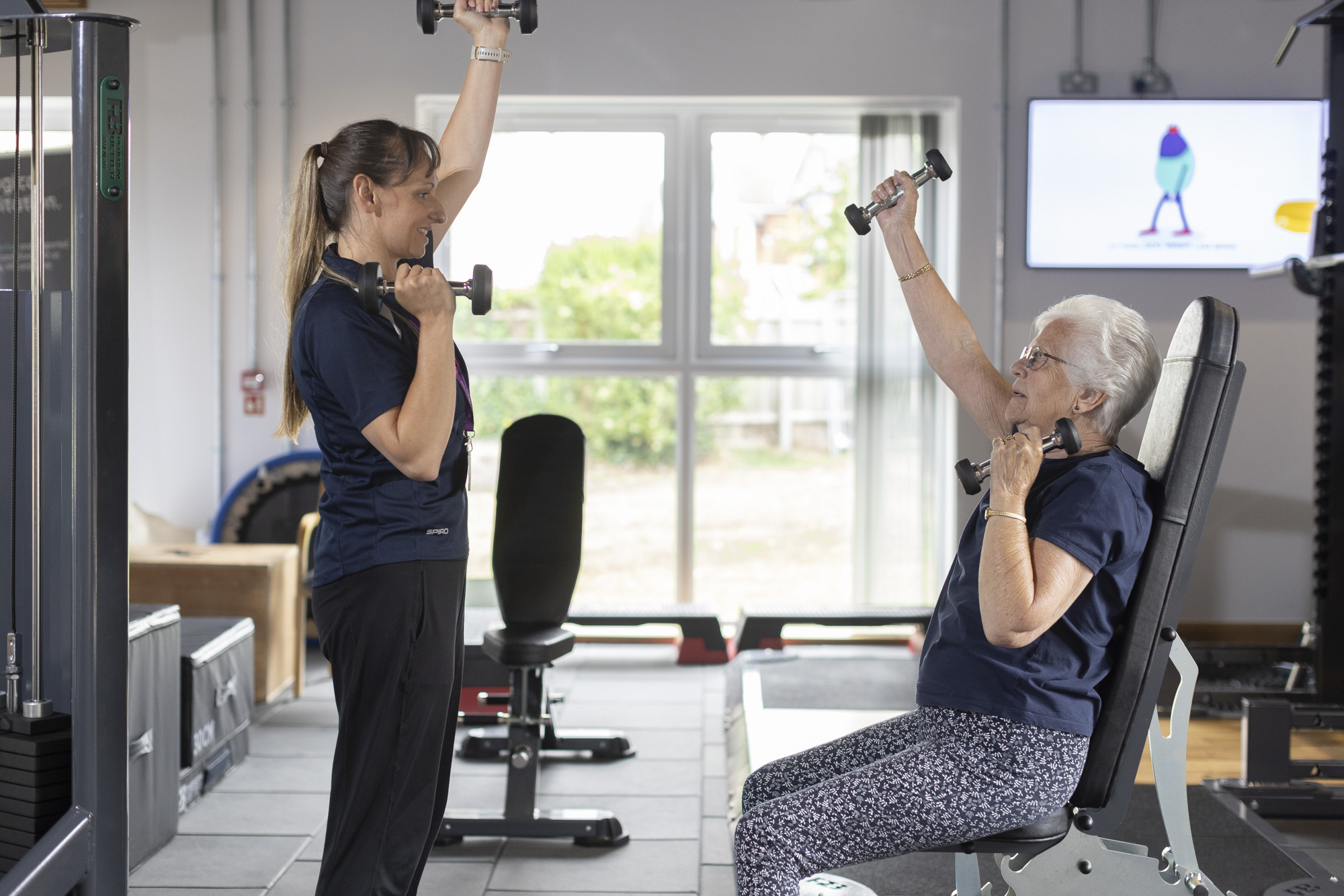 patient and instructor mirroring movements during a class