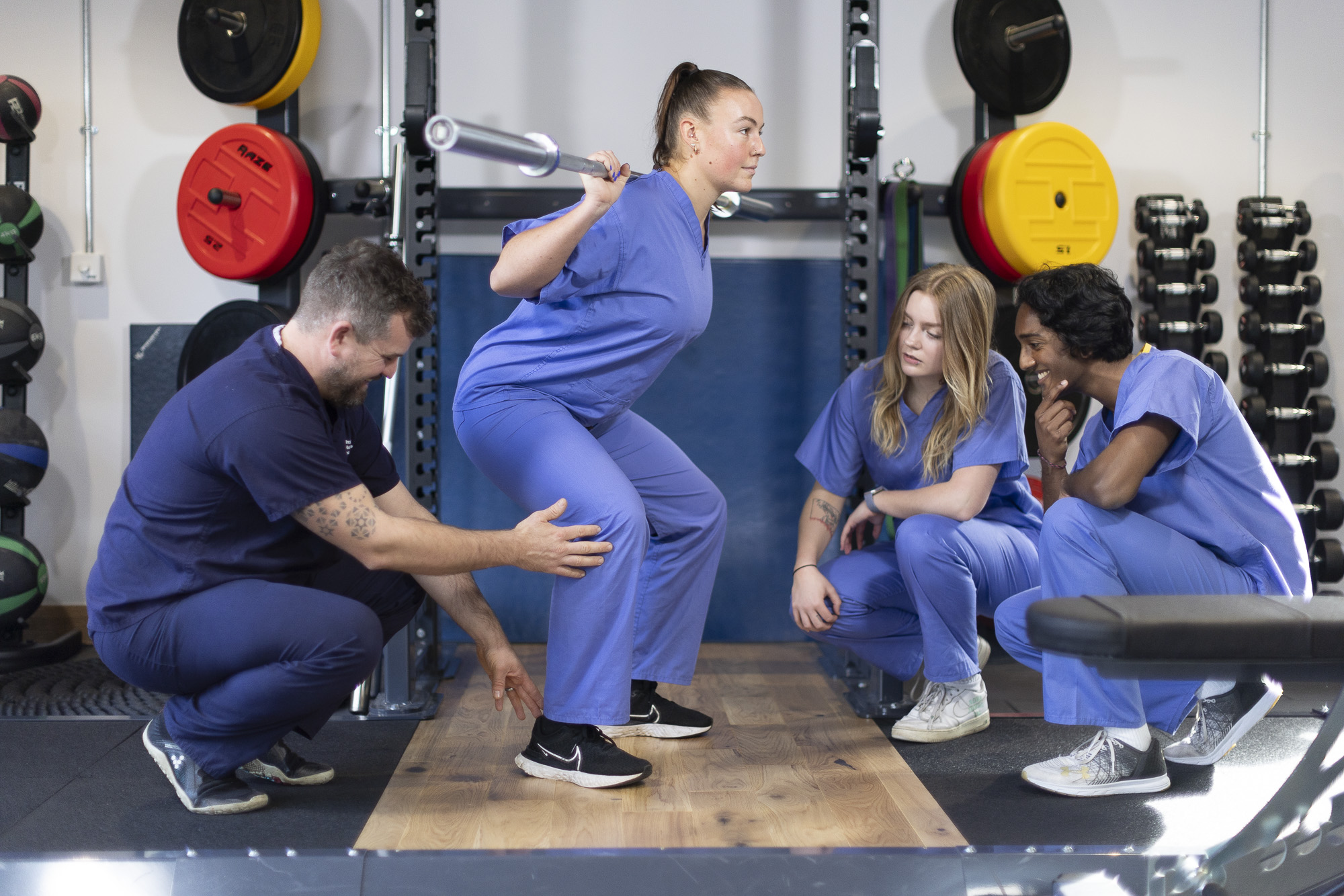 clinician instructing students how to perform physical assessments