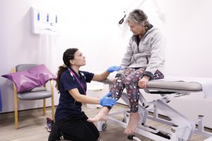 Physiotherapist in consultation with female patient