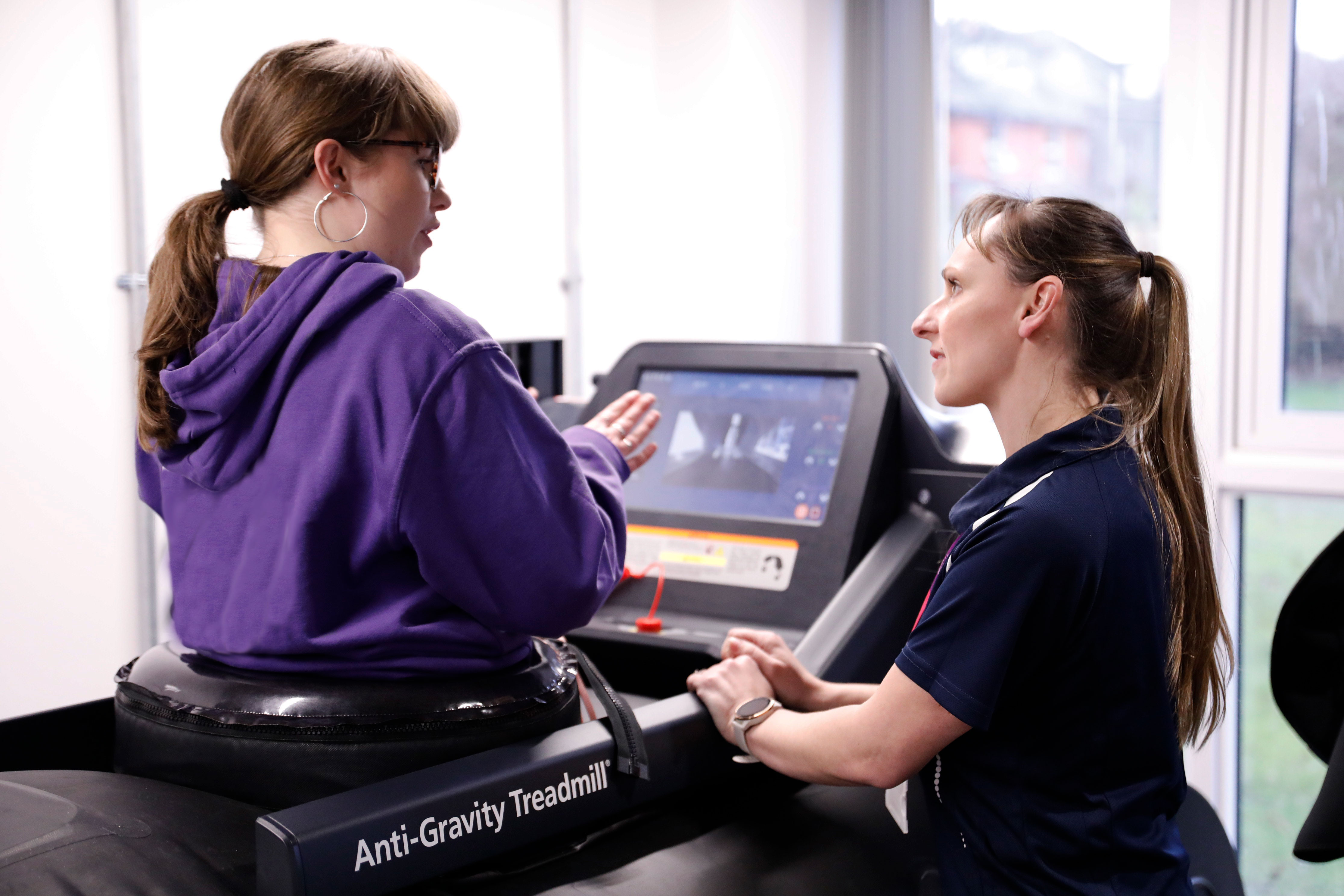 young patient using the AntiGravity Treadmill under the supervision of her clinician