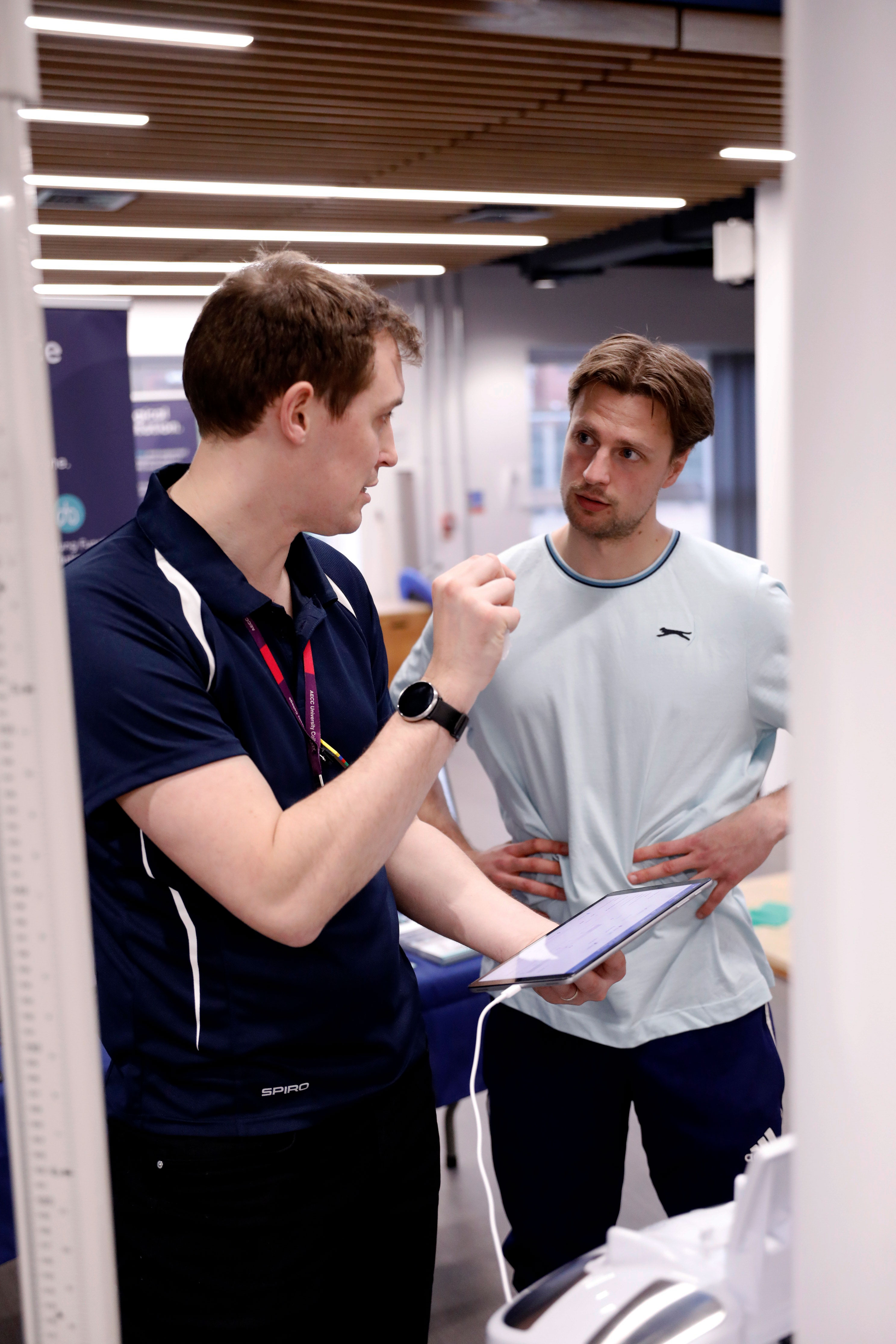 Clinician explaining data on a health test to patient who listens intently