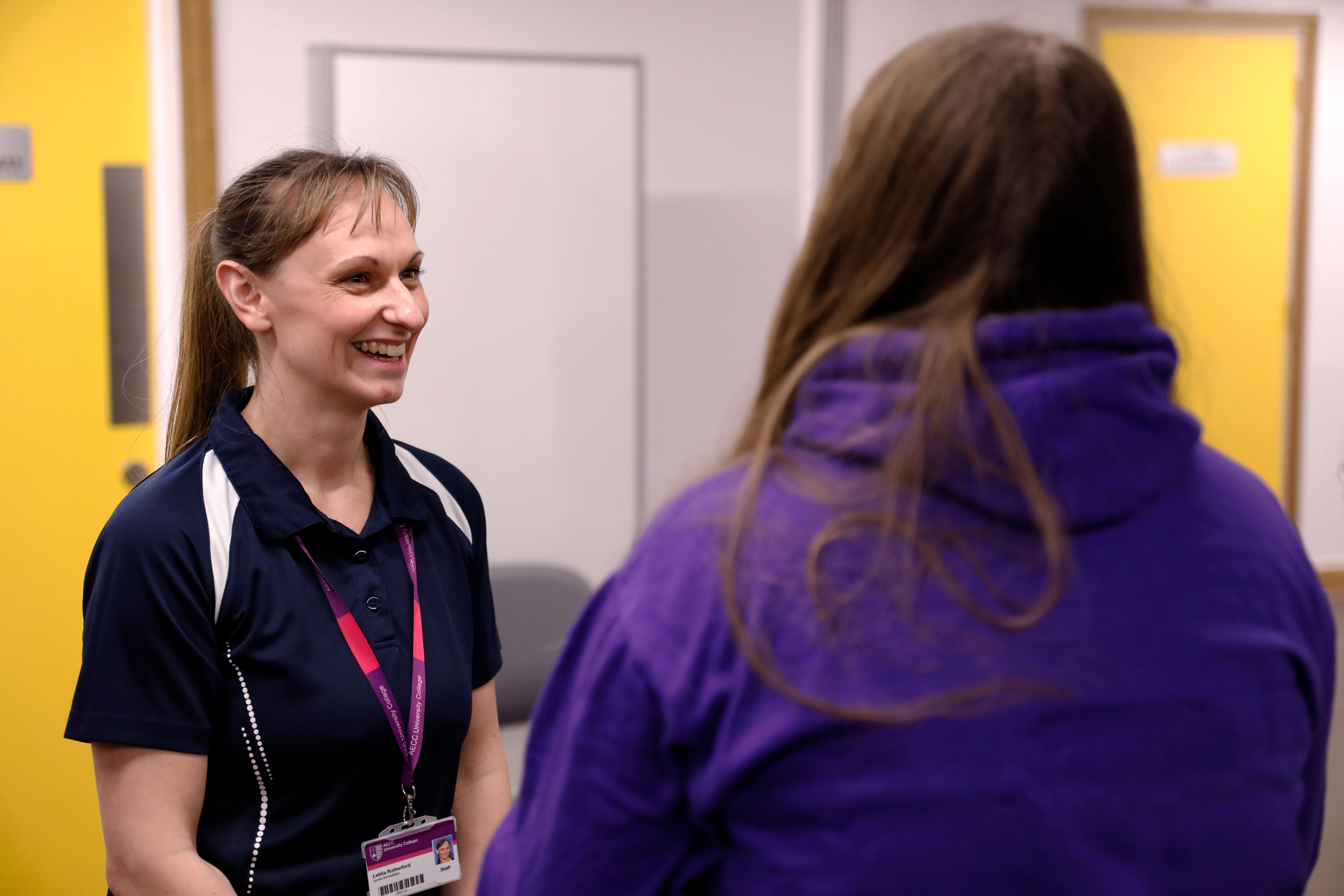 over the shoulder shot of a clinician and her patient in conversation