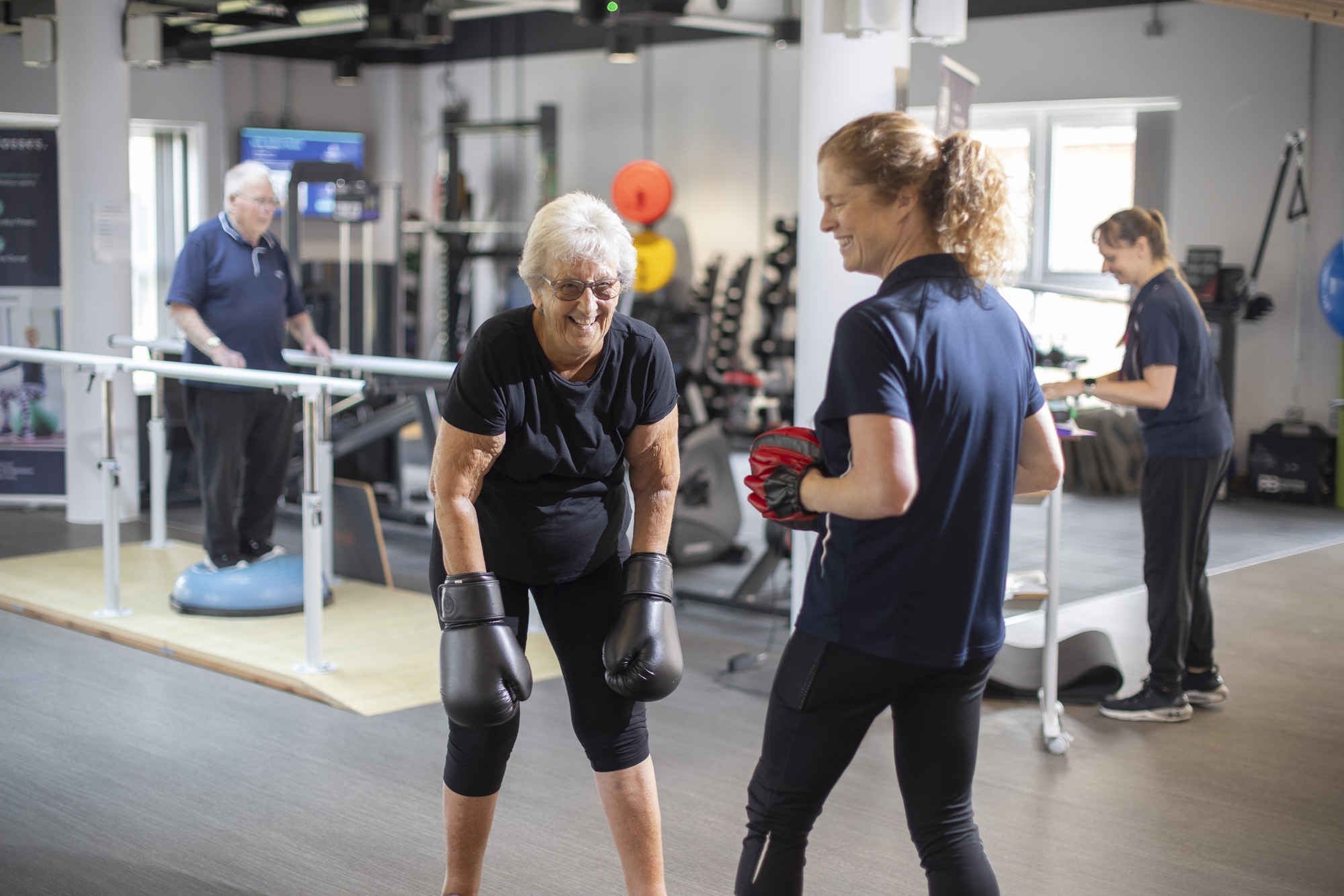 multiple patients during a class performing different exercises