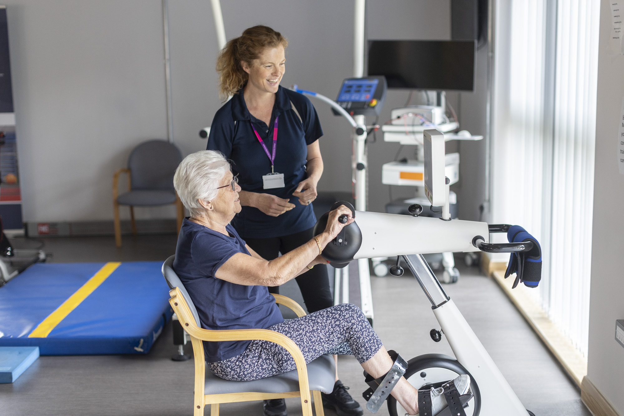 clinician and patient on exercise machine