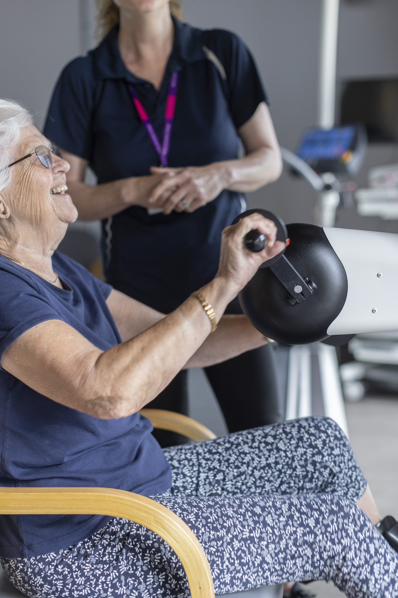 clinician and patient on exercise machine