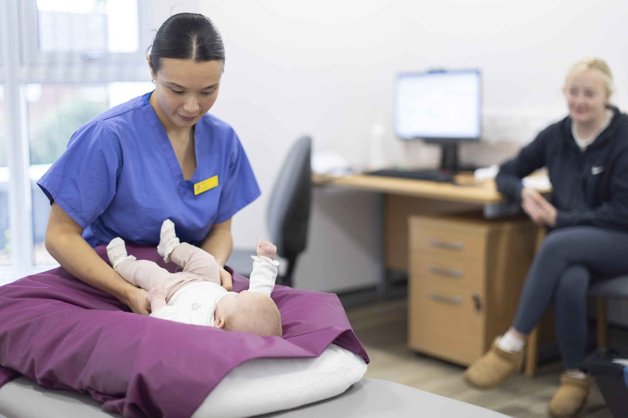 placement chiropractic student holding baby during paediatric clinic