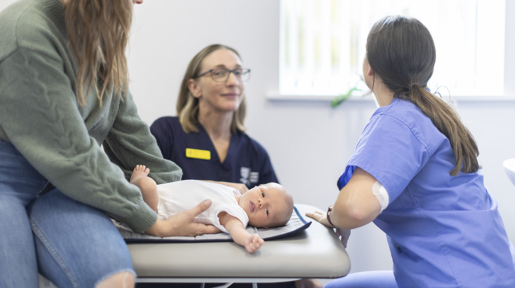 placement chiropractic student holding baby during paediatric clinic