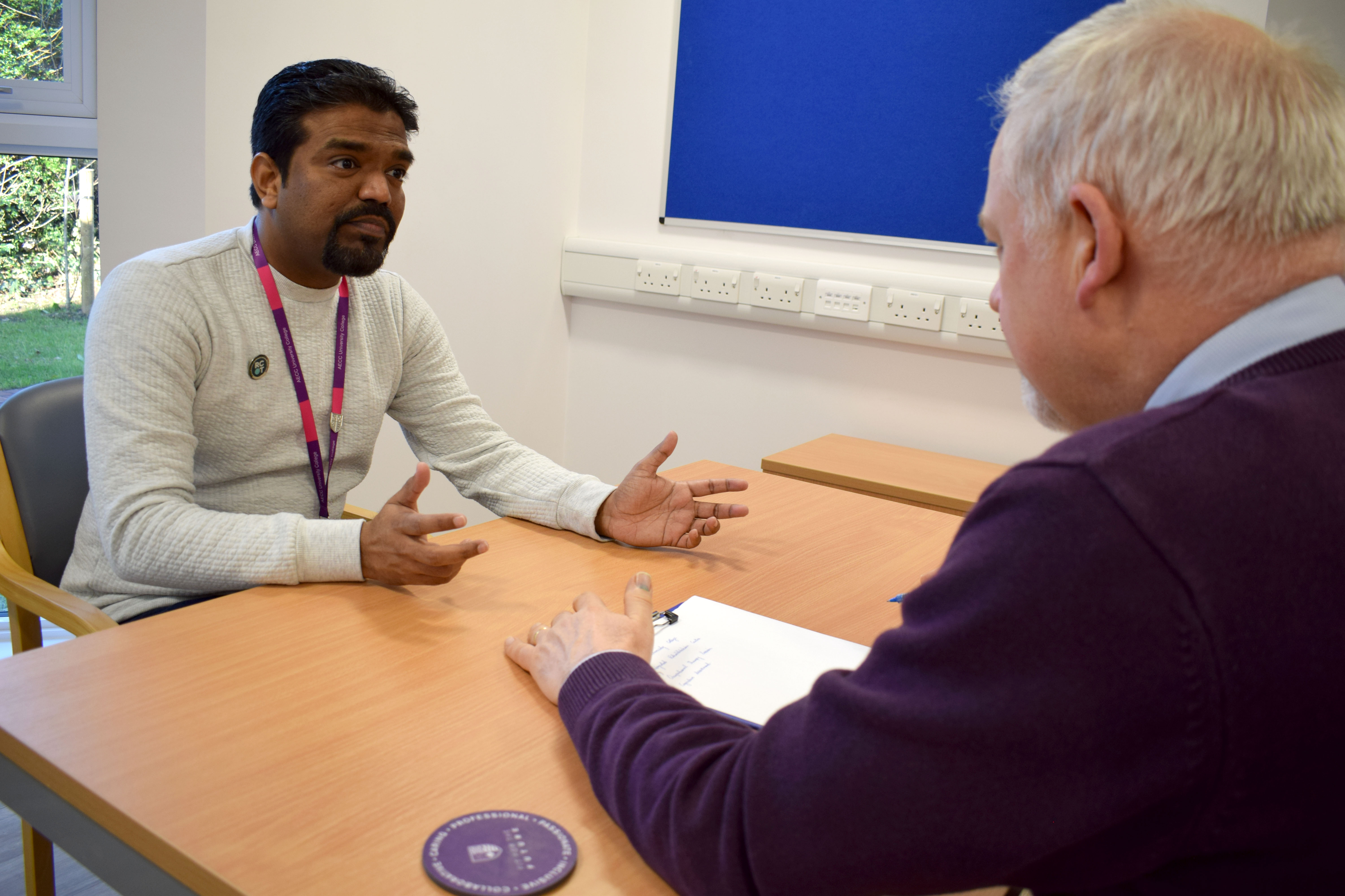 physiotherapist showing his patient a results chart