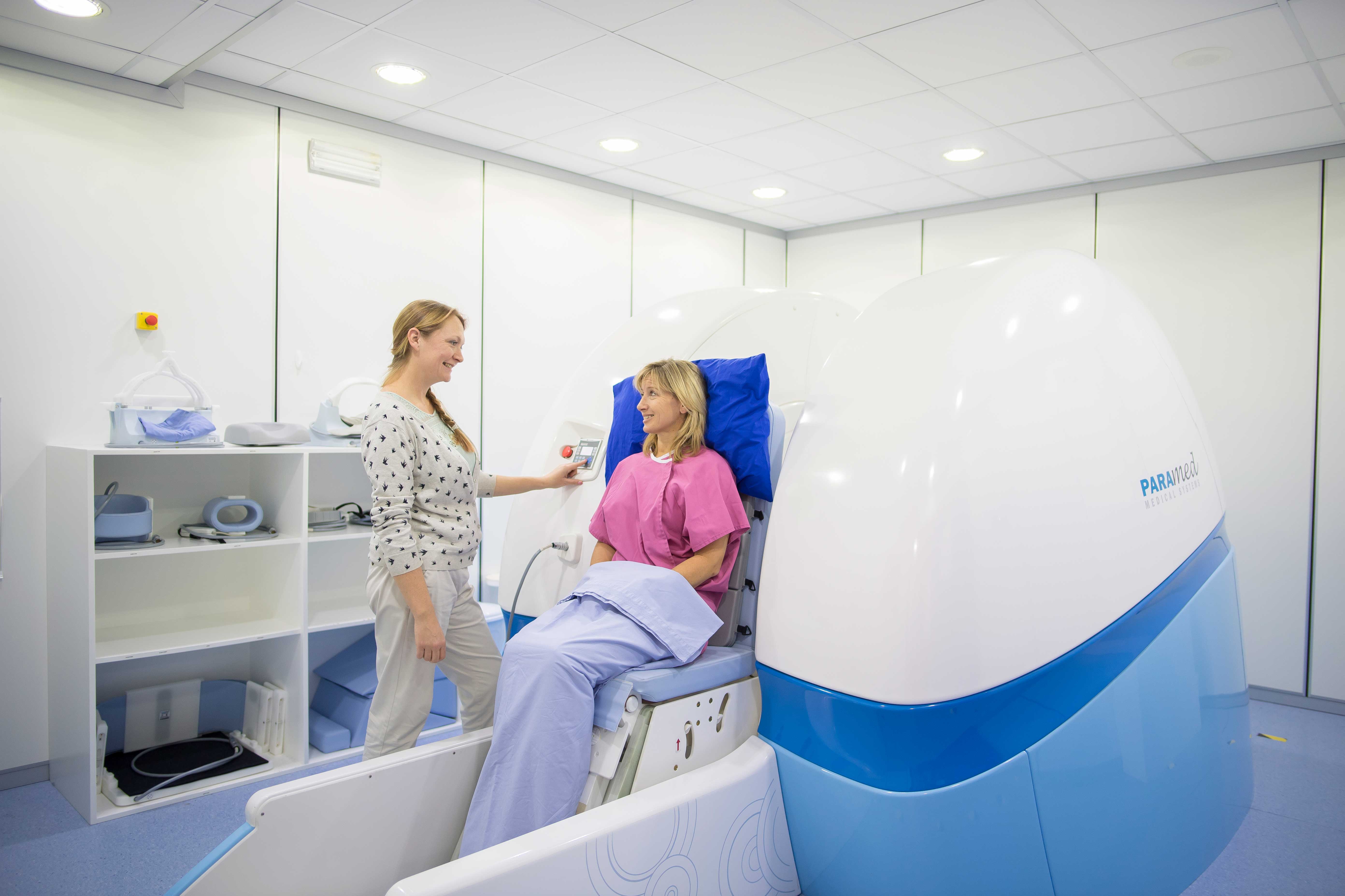 Patient in the open upright MRI machine at AECC UC