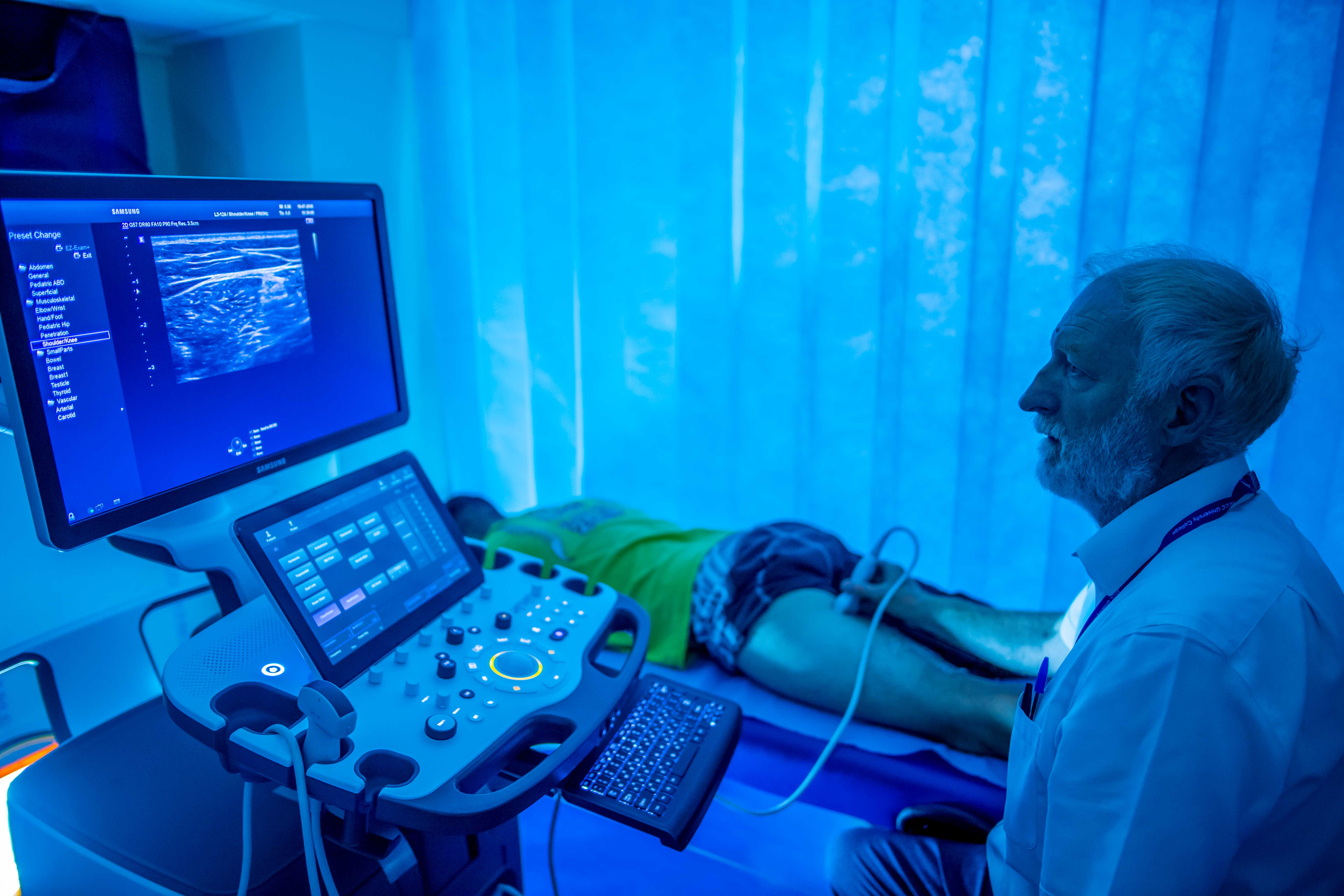 Ultrasound scan taking place in blue lit room