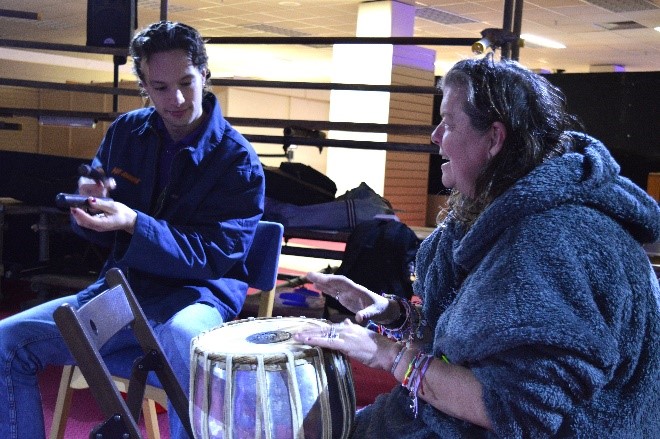 Two people playing music at community health and wellness event