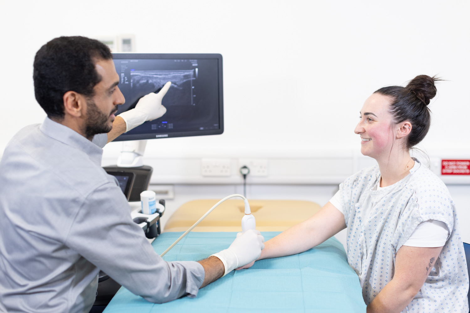 Radiologist explaining scan to a patient during an ultrasound