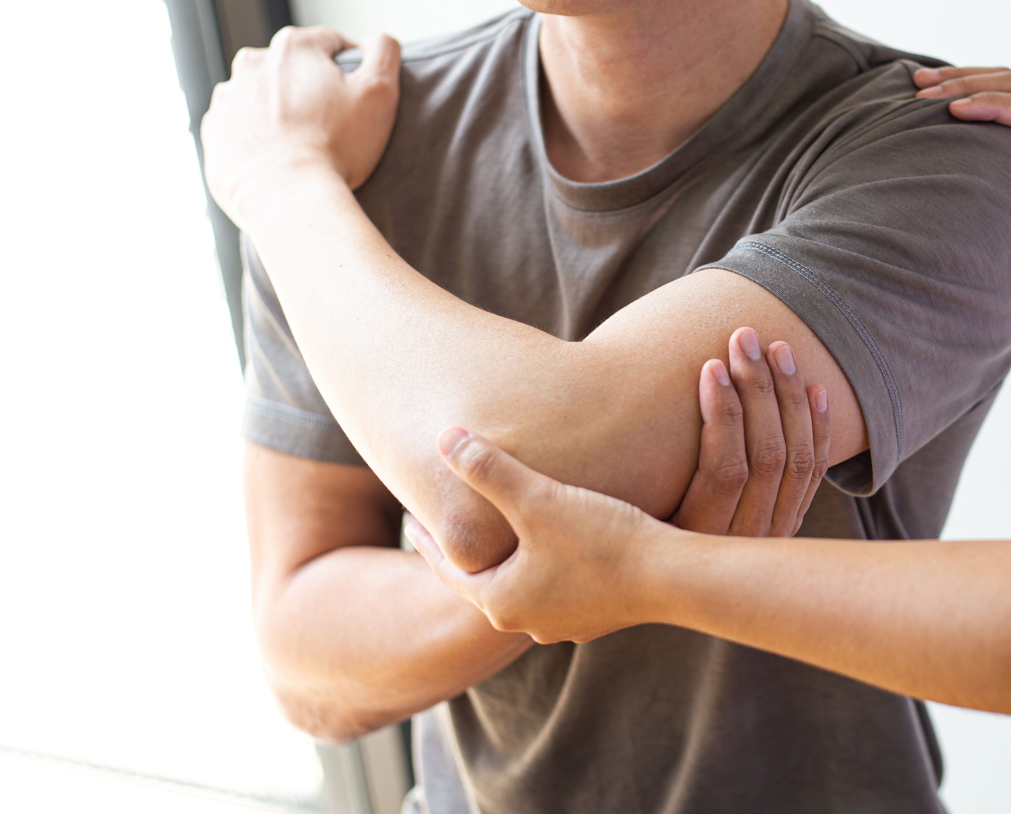 Therapist treating patient's arm, shoulder and elbow